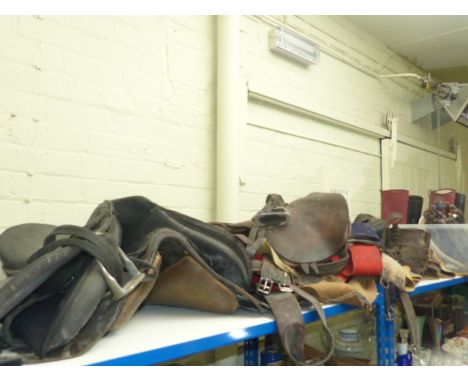 Large collection of horse tack including saddles, two pairs of riding boots, vintage skis and poles, etc