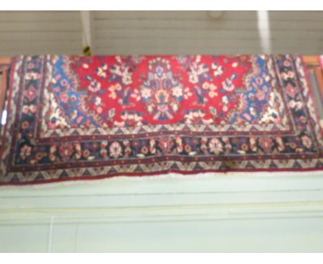 Red ground Persian design carpet 3.42 x 2.14