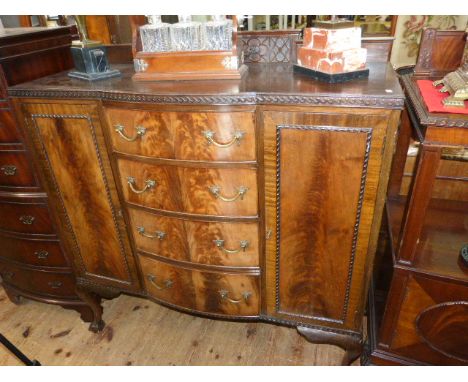 1920's mahogany Chippendale style bow front centre cabinet having four central drawers flanked by two cupboard doors