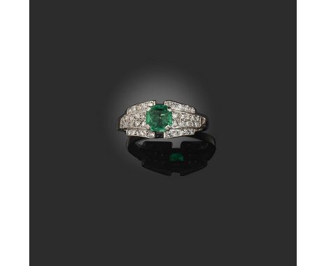 An emerald and diamond half hoop ring, set with a square emerald-cut emerald within stepped diamond shoulders in white gold, 