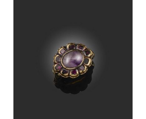 An amethyst and ruby ring, circa 1800, designed as a floral cluster, set with a cabochon amethyst within a border of flat-cut