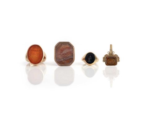 A collection of intaglio seal jewels, 19th century and 20th century, comprising: a carnelian intaglio depicting a coat of arm