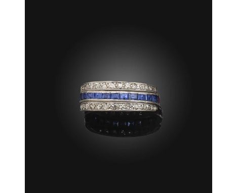 An Art Deco ruby, sapphire and diamond 'Day and Night' ring, early 20th century, designed as a band of calibré-cut rubies and