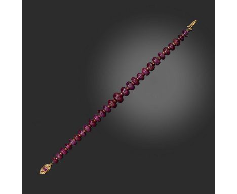 A ruby bracelet, composed of graduated ruby beads with gold spacers, to a clasp set with a step-cut ruby and single-cut diamo