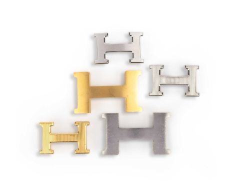 Hermès, a collection of belt buckles, comprising: five buckles, each designed as the letter H, in brushed and fluted finishes