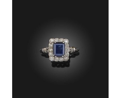 Alabaster &amp; Wilson, a sapphire and diamond cluster ring, the step-cut sapphire set within a surround of diamonds in plati