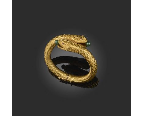 A gold serpent bangle, the stylised double-headed snake with a textured body, ruby eyes and an aventurine quartz bead in each