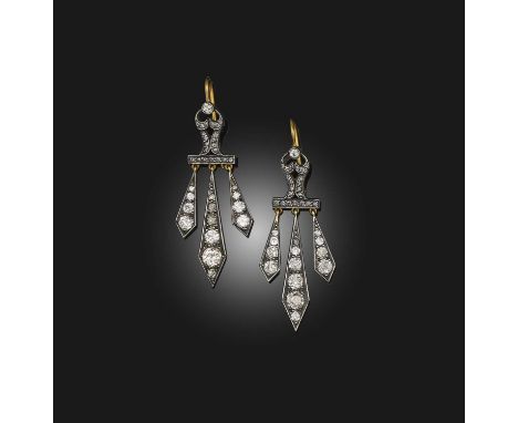 A pair of diamond drop earrings, each designed as a scrolled surmount suspending three pendants, set with rose-cut and circul