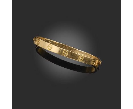 Aldo Cipullo for Cartier, a gold 'LOVE' bangle, circa 1970, designed as a manacle, fastened at each end with a screw, decorat