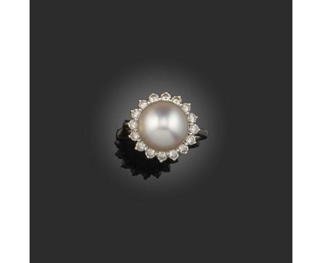 A cultured pearl and diamond ring, of cluster design, set with a cultured pearl measuring 11.6mm diameter, within a border of