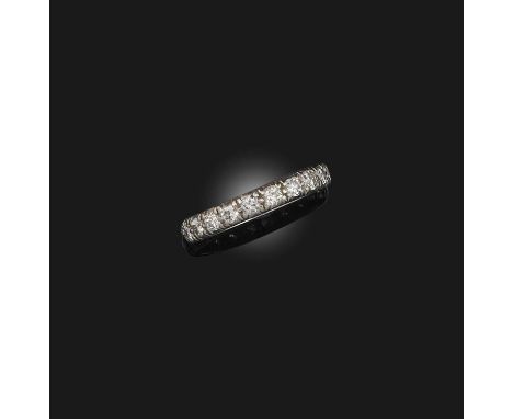 A diamond eternity ring, early 20th century, set with a continuous line of circular-cut diamonds, mounted in platinum, size P