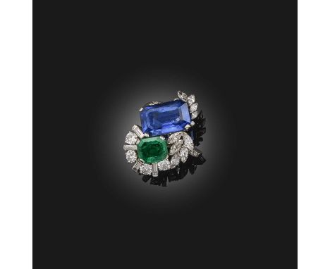 A sapphire, emerald and diamond ring, of toi et moi design, set with a step-cut sapphire weighing 8.21 carats and a step-cut 
