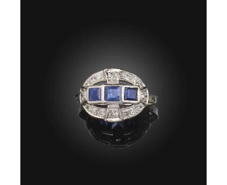A sapphire and diamond cluster ring, set with three step-cut sapphires within diamond surround, in iridium and platinum, size