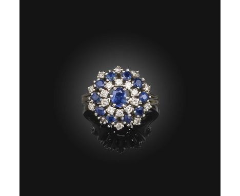 A sapphire and diamond cluster ring, set with graduated circular-cut sapphires and diamonds in white gold, size P