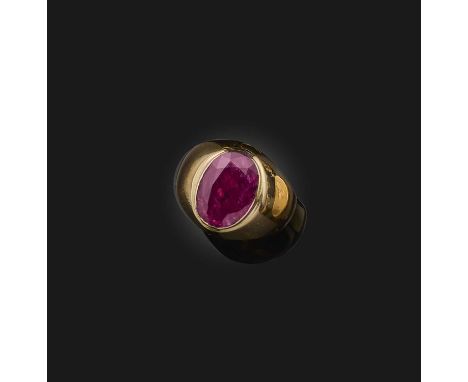 A ruby solitaire ring, rubover-set with an oval ruby weighing 2.68 carats, in a plain mount of polished gold, size RAccompani
