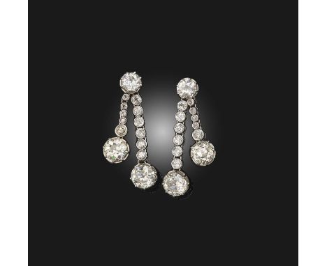 A pair of diamond earrings, early 20th century composite, each designed as a pair of asymmetrical drops, set with cushion-sha