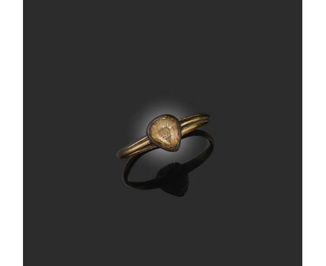 A 'Stuart Crystal' ring, late 17th/early 18th century, set with a pear-shaped rock crystal covering a monogram in gold wire, 