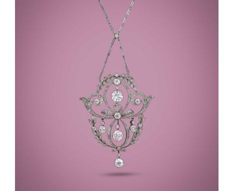 A fine Belle Epoque diamond pendant, circa 1910, designed as sinuous ribbon bows accented with sprays of laurel leaves, set w