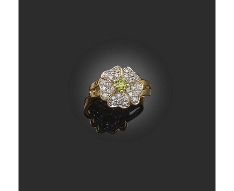A green diamond and diamond ring, designed as a flower, centring on a brilliant-cut diamond of green tint weighing approximat