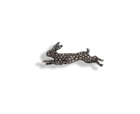 A diamond-set hare brooch, pave-set with rose-cut diamonds and ruby eyes in silver and gold, length 4.1cm