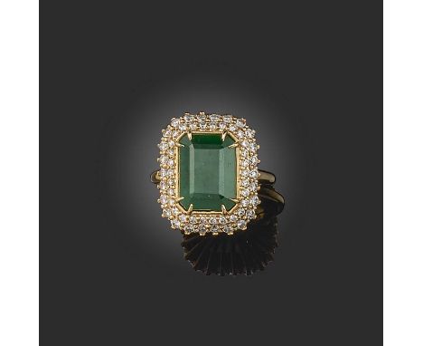 An emerald and diamond ring, claw-set with a step-cut emerald weighing 6.51 carats, within a double border of brilliant-cut d