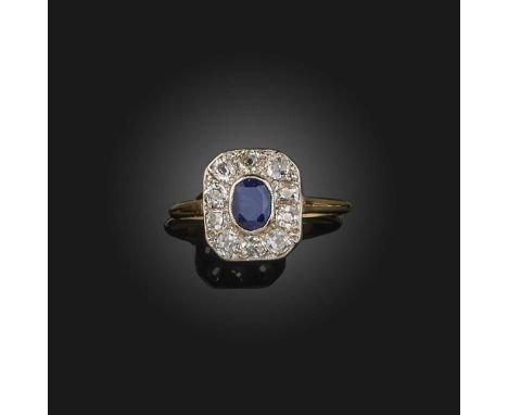 A sapphire and diamond cluster ring, set with an oval-shaped sapphire within a surround of diamonds in platinum and 18ct yell