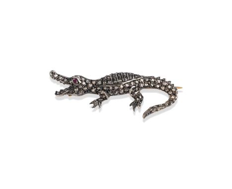A diamond-set crocodile brooch, pave-set with rose-cut diamonds and ruby eyes in silver and gold, length 4.5cm