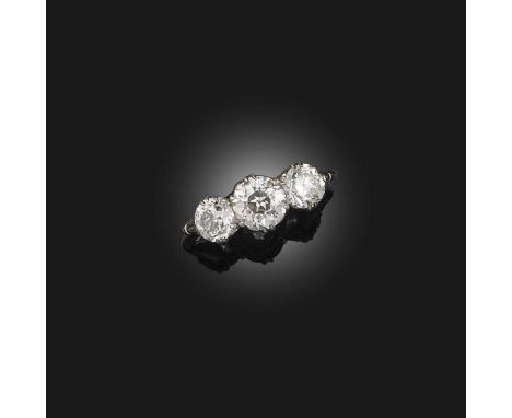 A three-stone diamond ring, early 20th century, claw-set with three circular-cut diamonds totalling approximately 2.20 carats