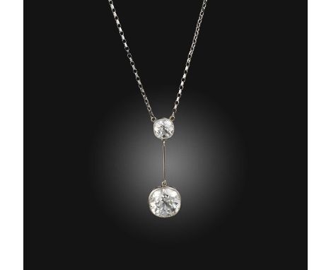 An impressive diamond pendant necklace, early 20th century, the pendant composed of two cushion-shaped diamonds weighing appr