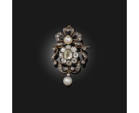 A diamond and pearl brooch, late 19th century, centring on a cluster of cushion-shaped diamonds, within a foliate scroll bord