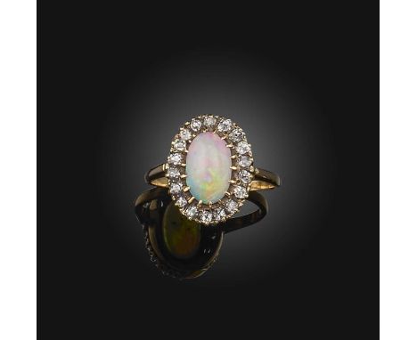An opal and diamond cluster ring, set with a central solid white opal within a surround of cushion-shaped diamonds in gold, s