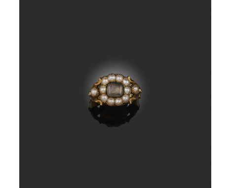 A Georgian pearl and hairwork mourning ring, early 19th century, centring on a glazed panel of woven hairwork, to a border an