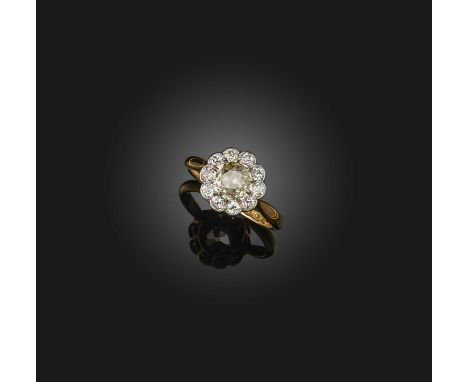 A diamond ring, early 20th century, of cluster design, set with a circular-cut diamond weighing approximately 0.50 carats, wi