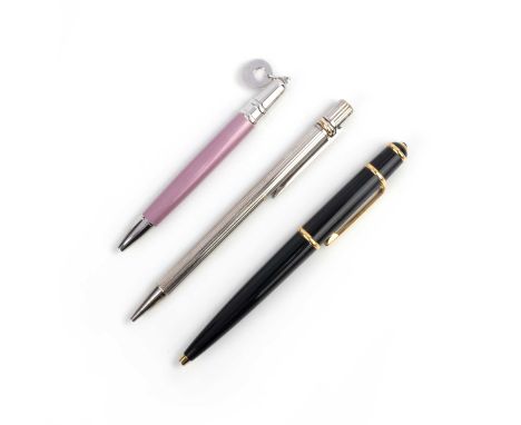 Cartier, three pens, comprising: a gilt and black enamel ball point pen, length 13.5cm, signed Cartier, numbered 316433; a pi