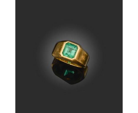 An emerald-set gold ring, the step-cut emerald set in plain yellow gold setting, size IA verbal report from GCS states that t