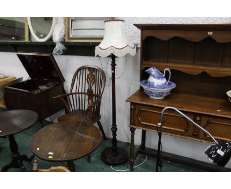 Carved wood standard lamp with cream tasselled shade 