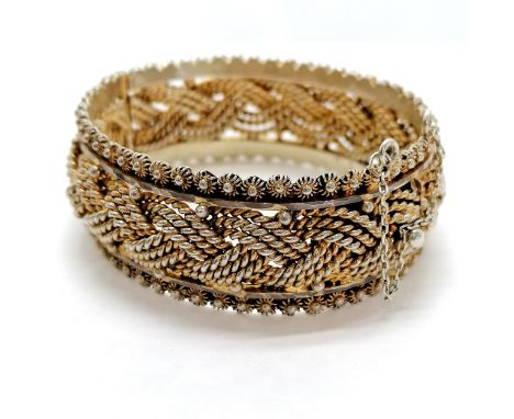 Good quality silver gilt filigree heavy gauge bangle. Foreign marks to clasp, 63g. approx 18cm circumference Condition report