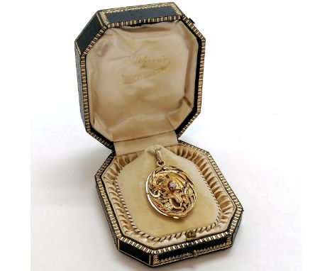 Antique gold locket with sliding plique-a-jour panel with dragon detail which is set with a diamond to the centre in original