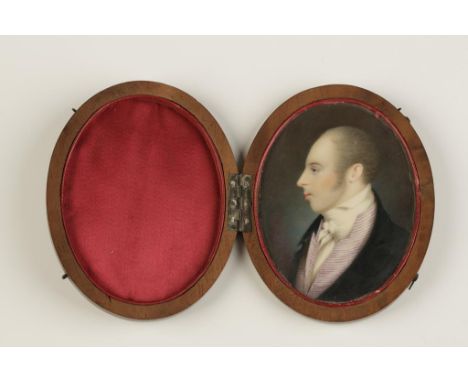 AN OVAL PAINTED PROFILE PORTRAIT MINIATURE OF A GENTLEMAN, wearing a violet striped waistcoat, contained in a silk lined wood