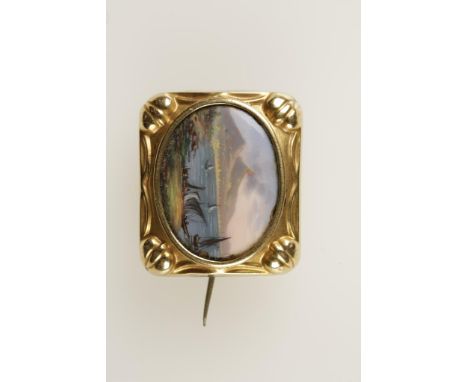 A YELLOW METAL AND ENAMEL PLAQUE BROOCH (tests as gold), the oval panel with a hand-painted scene of Mt. Vesuvius, Italy.