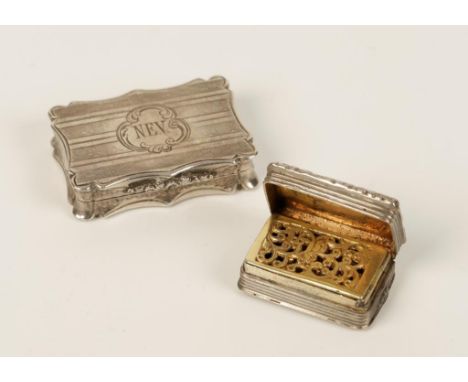 A VICTORIAN VINAIGRETTE of shaped rectangular form with engine-turned decoration, initialled N.E.V., the gilt interior with a