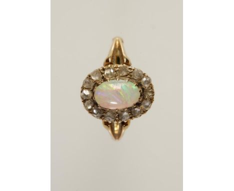 AN OPAL AND DIAMOND CLUSTER RING, the central oval opal claw-set and surrounded by a rose-cut diamond border, to an unmarked 