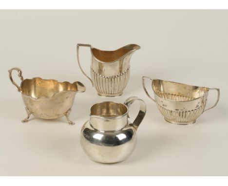 A VICTORIAN MILK JUG of circular bellied form, by P & Co., a sauceboat, a part fluted cream jug and sugar bowl, of mixed make