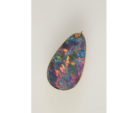 A BLACK OPAL DOUBLET BROOCH of elongated pear form, in a deep unmarked yellow metal mount inscribed "JMH 1935", 42mm long. Se