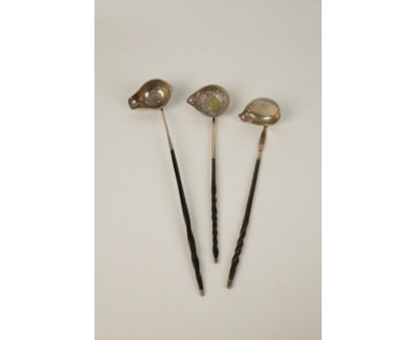 A GEORGE III SINGLE LIPPED PUNCH LADLE with baleen twist handle, marks rubbed, London assay, circa 1780, 13" long, and two ot