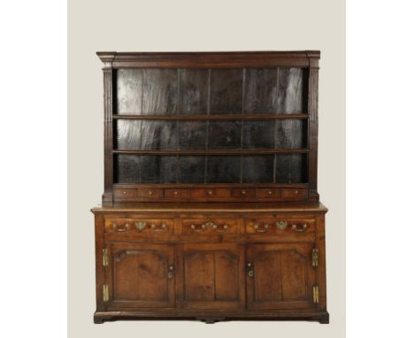 A GEORGE III OAK DRESSER, the raised back with three shelves and boarded back, beneath a moulded cornice and fluted columns, 