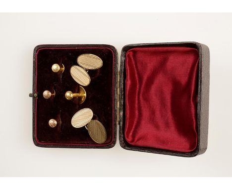 A PAIR OF 9CT YELLOW GOLD CUFFLINKS, each of oval form with engine turned decoration, the reverse hallmarked, (c.6.8grams all