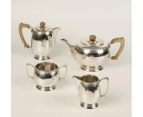 AN ART DECO STYLE FOUR PIECE TEA SET of tapering circular form, with stepped wooden handles, disc finials with stylised engra