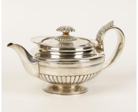 A GEORGE III TEAPOT of compressed circular form, with fluted flowerhead finial, scroll handle and part-fluted decoration, on 