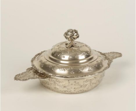 A GERMAN ECUELLE of circular form, the pull-off cover with a rosebud finial, lug handles, the body embossed with floral sprig